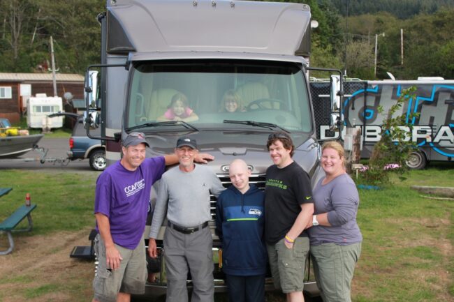 Group of people in front of a motor home